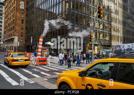 steam leak coming out a temporary chimney at a busy midtown street in Manhattan Stock Photo