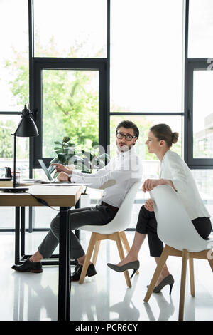 side view of young attractive managers working together at modern office Stock Photo