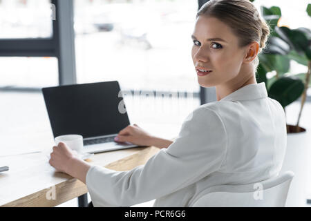 successful young businesswoman working with laptop at modern office Stock Photo
