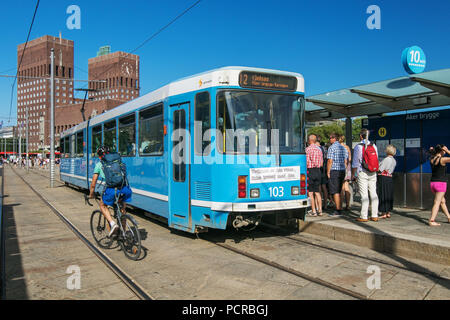 Oslo, Norway, July 21, 2018: People are boarding a tramway at Aker Brygge stop. Stock Photo