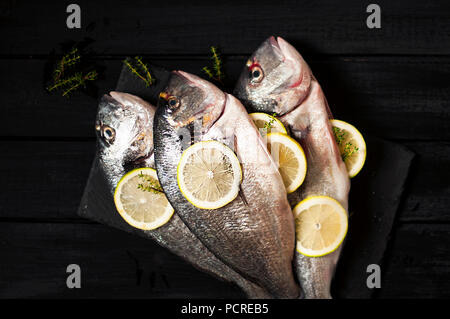 Fish dorada on a frying pan. Eating a healthy diet. Top view Stock Photo