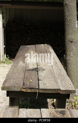 Covered wagon bench made of weathered wood. Stock Photo