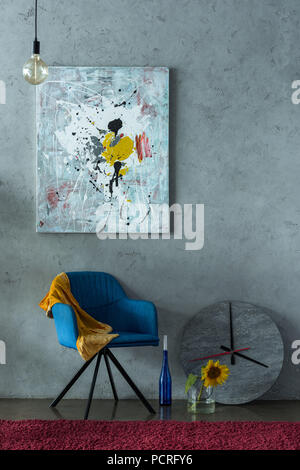 blue chair and modern painting on wall in office Stock Photo