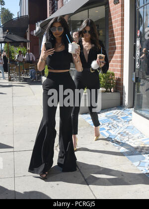 BEVERLY HILLS, CA - JULY 28: Kylie Jenner, 17, continues to flaunt new band on wedding finger that may be from beau Tyga, 25 as seen here on a Greek yogurt run with sister Kendall Jenner on July 28, 2015 in Beverly Hills, California.  People:  Kylie Jenner, Kendall Jenner Stock Photo