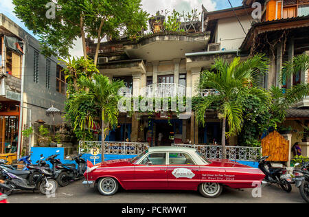 Red Chevrolet Biscayne in front of a cafe in Ubud, street scene, Ubud, Bali, Indonesia, Asia Stock Photo