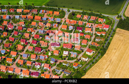 Aerial view, new housing estate, brick buildings with red tiled roofs, single-family houses and terraced housing, home gardens, Billerbeck, Münsterland, North Rhine-Westphalia, Germany Stock Photo