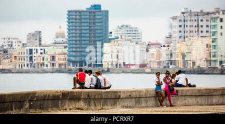 Cuban teenagers on the walls of Malecon, La Habana, Havana, La Habana, Cuba, Cuba Stock Photo