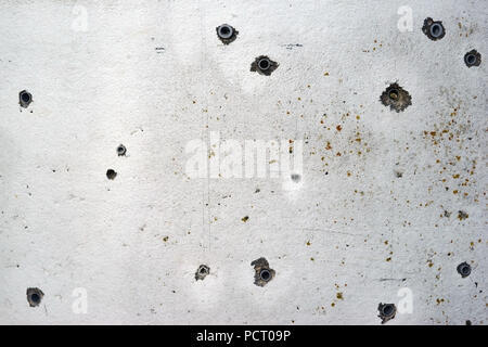 Different sizes of holes with plastic dowels in concrete Stock Photo