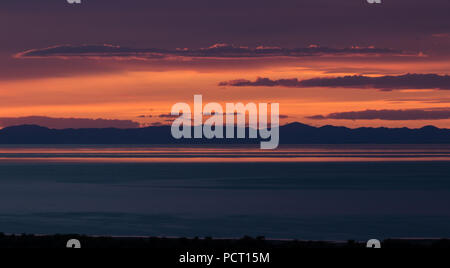 Beautiful sunset on Antelope Island in the Great Salt Lake looking into the distant mountains across the lake.