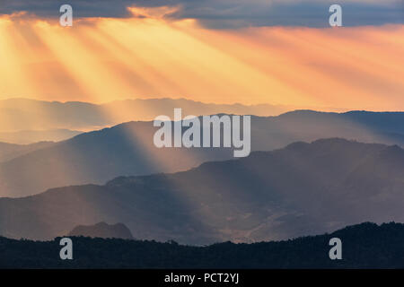 Rays of light shining through dark clouds . dramatic sky with cloud Stock Photo