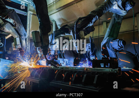 Robot are welding metal part Stock Photo