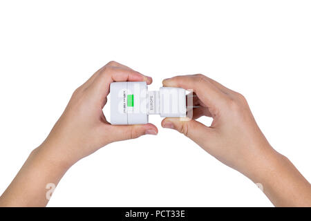 hand holding Electric plug isolated on white background Stock Photo