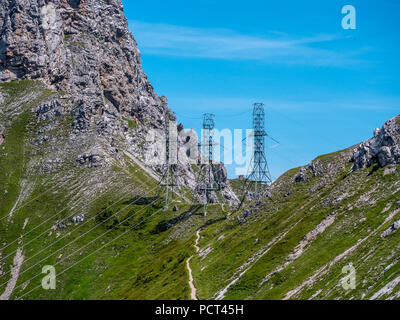 three high voltage post power poles high up in the mountains high voltage tower switzerland alps Stock Photo