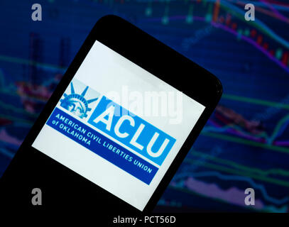 KIEV, UKRAINE - August 4, 2018: The American Civil Liberties Union logo seen displayed on a smartphone with a background of a stock market shedle. The American Civil Liberties Union (ACLU) is a nonprofit organization Stock Photo