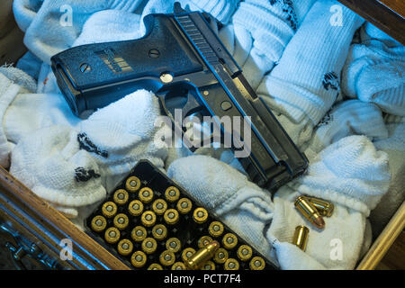 Semi-automatic pistol in sock drawer, USA Stock Photo