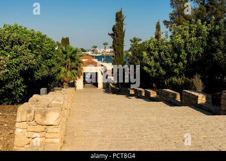 Gate entrance and entry road to Paphos Archaeological Park in Cyprus Stock Photo