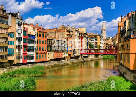 Red bridge over Onyar River built by Eiffel company, colorful facades over Onyar River, Girona, Catalonia, Spain Stock Photo
