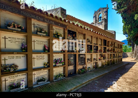 Graves in front of the Romanesque Church of Santa Maria de Porqueres, Porqueres, Catalonia, Spain Stock Photo