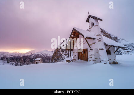 Small white chapel in winter on top of Falzarego pass in the Dolomites, Cortina d'Ampezzo, Belluno, Veneto, Italy Stock Photo