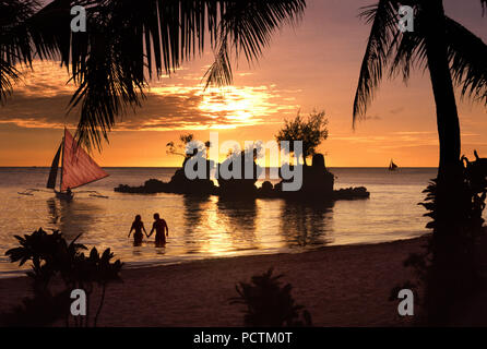 couple at sunset in Boracay, Philippines, Asia Stock Photo