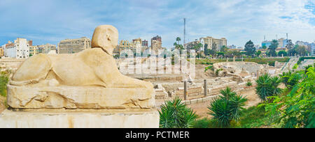 The antique statue of sphinx in Kom Ad Dikka archaeological site with Roman amphitheatre on background, Alexandria, Egypt. Stock Photo
