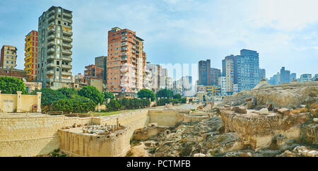 The Amoud Al Sawari archaeological site with Pompey's Pillar and the ruins of Serapeum Temple is neighboring with residential high-rises and slums of  Stock Photo