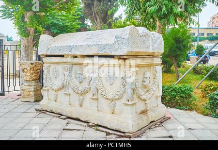 The antique carved sarcophagus at the entrance to Catacombs of Kom El Shoqafa archaeological site, containing objects of Pharaonic, Greek and Roman fu Stock Photo