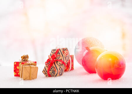 Colored balls and christmas presents on snow, with abstract background and copy space. Christmas backgroundand and greeting card Stock Photo
