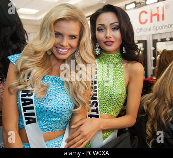 DORAL, FL - JANUARY 25:  Tegan Martin, Miss Australia, Aiday Issayeva, Miss Kazakhstan 2014 gets her makeup done by an O.P Makeup artist backstage at the 63rd Annual Miss Universe Pageant at Trump National Doral on January 25, 2015 in Doral, Florida.  People:  Tegan Martin, Miss Australia, Aiday Issayeva, Miss Kazakhstan Stock Photo