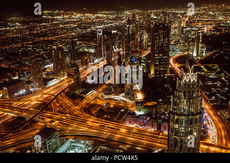 Aerial view of downtown Dubai and skyscrapers at night from the top of Burj Khalifa