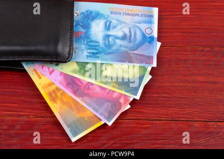 Swiss money in the black wallet Stock Photo