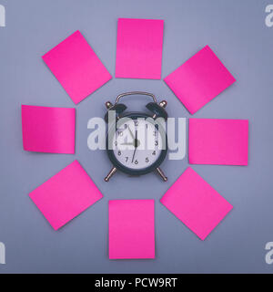 Pink sticky notes and clock, memory concept background. Stock Photo