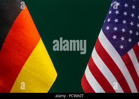 Flags United State of America and Germany with green background. Concept of international relations. Stock Photo