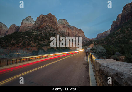 Headlight trails over Virgin Rive; scenic drive through Zion Canyon, which lets visitors explore Zion National Park near Springdale, Utah, by vehicle. Stock Photo