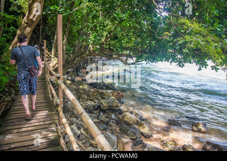 Cliffside wooden path over the water from Ao Nang beach to secluded centara resort beach Stock Photo