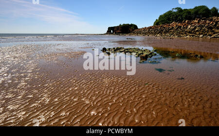 Dawlish Warren beach near Langstone Rock, showing rock armour along the sea wall. Stock Photo
