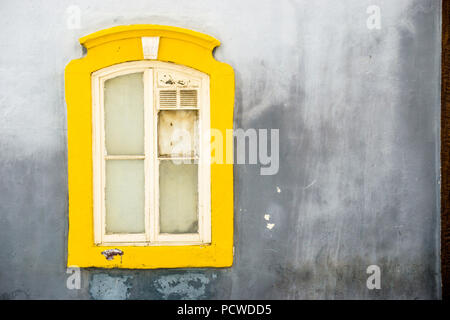 Old wooden window decorated with yellow frame, Portugal Stock Photo