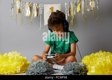 Cute boy playing video games at home Stock Photo