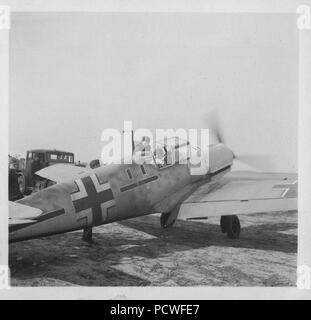 Image from a photo album relating to II. Gruppe, Jagdgeschwader 3: 15 September 1940: Stabsschwarm JG3 Messerschmitt Bf109E-4 (5205). Engaged by fighters during free-lance sortie and radiator severely damaged in combat. Possibly that attacked by P/O R.H. Holland of No. 92 Squadron. Engine overheated so attempted a forced-landing but crashed into outbuildings on Tarpots Farm, Bilsington, 12.15 p.m. FF Oberstlt Hasso von Wedel captured unhurt. Aircraft Black  — + —  100% write-off. Farmer's daughter, 4-year-old Vera Daw, was killed in this crash, her mother also later dying of injuries. Stock Photo