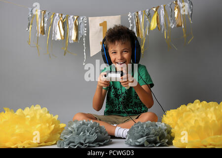 Cute boy playing video games Stock Photo