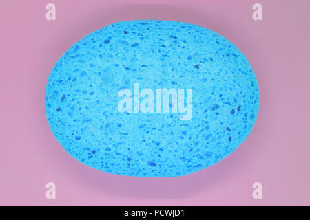 Abstract composition of blue sponge on pink background surface Stock Photo