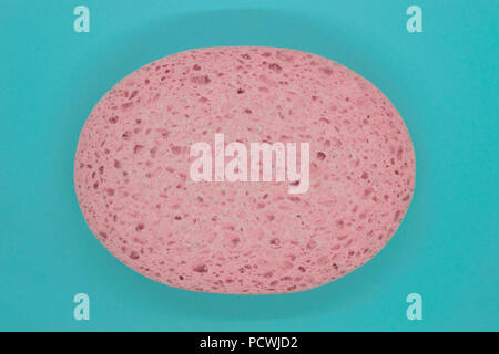 Abstract composition of pink sponge on blue background surface Stock Photo