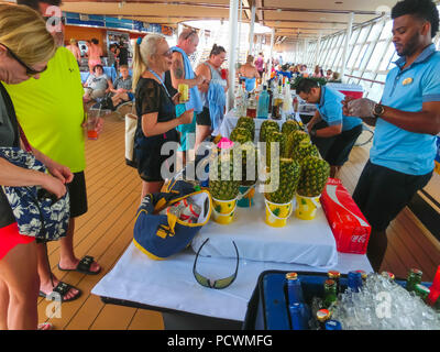 Cape Canaveral, USA - APRIL 29, 2018: The waiters with alcoholic drinks at luxury cruise ship Oasis of the Seas by Royal Caribbean. Stock Photo