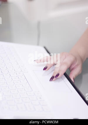 Womans hand on white computer keyboard. Copy space Stock Photo
