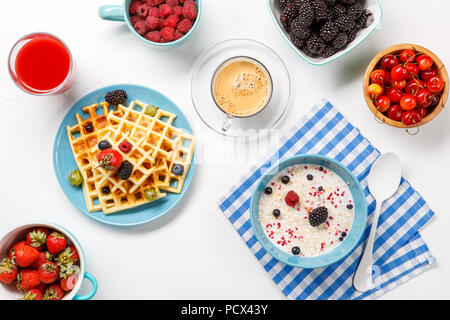 Photo of Viennese waffles, oatmeal, coffee, fresh berries Stock Photo