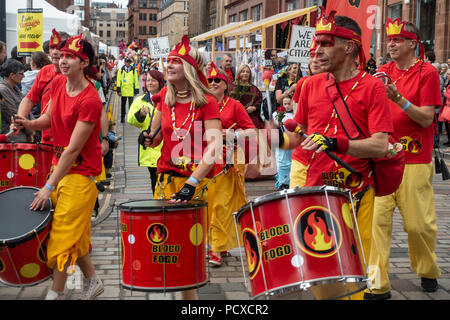 Glasgow, Scotland, UK. 04th August 2018. Samba band Bloco fogo from Kent participating in the Carnival Procession of the Merchant City Festival. The festival is part of Festival 2018 a city-wide cultural event running in parallel with Glasgow 2018, the European Championships. Credit: Elizabeth Leyden/Alamy Live News Stock Photo