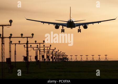 Richmond, British Columbia, Canada. 24th Apr, 2013. An Airbus A330 wide-body jet airliner lands at sunset, Vancouver International Airport, Canada. Credit: Bayne Stanley/ZUMA Wire/Alamy Live News Stock Photo