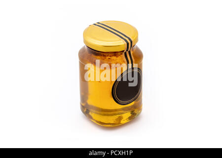 Studio shot of honey in glass jar isolated on white background. Stock Photo