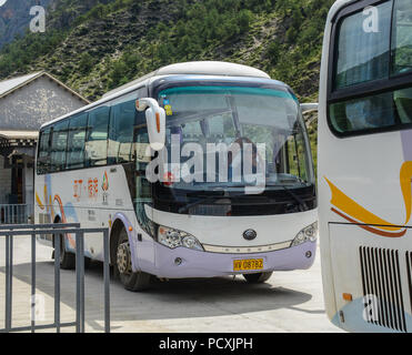 Daocheng, China - Aug 15, 2016. Tourist buses in Daocheng, China. Daocheng is located in the eastern Hengduan Mountains, Sichuan Province. Stock Photo