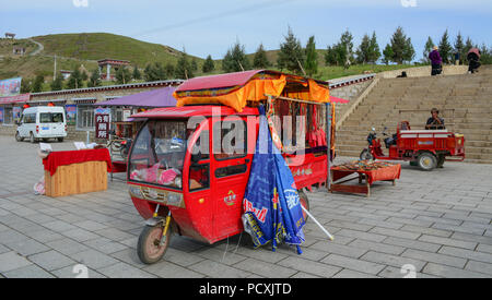 Daocheng, China - Aug 15, 2016. Selling souvenirs on the cart at Buddhist pagoda on mountain in Daocheng, China. Stock Photo